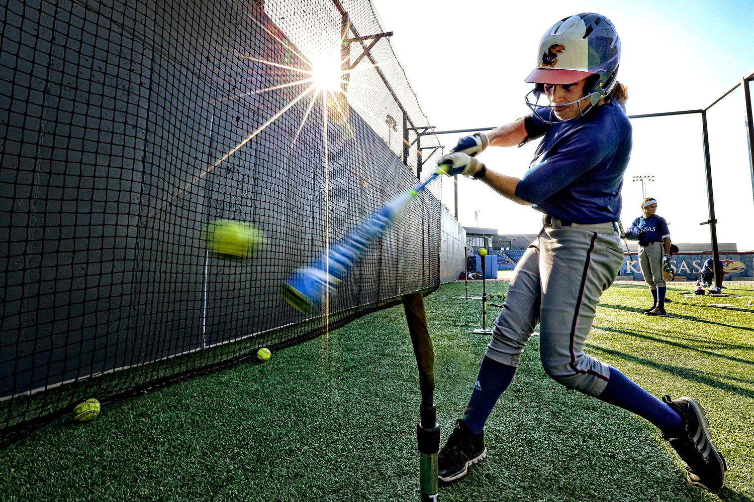 Erin McGinley hitting off a tee at softball